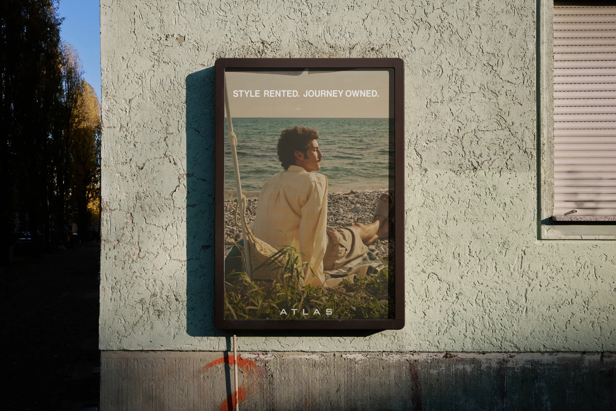 An ATLAS poster on a wall reading Style rented. Journey owned.