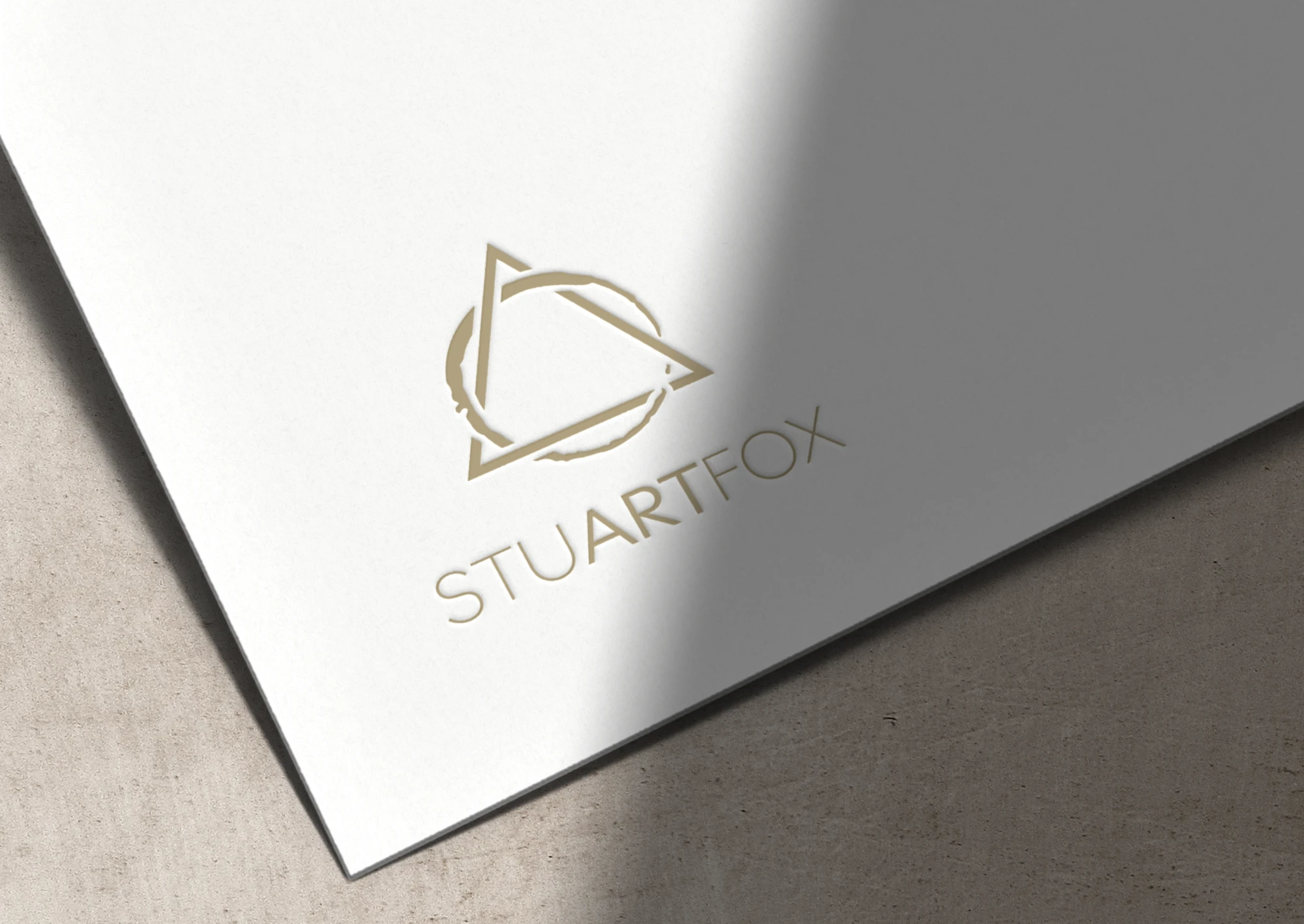 StuartFox logo embossed in gold on white card